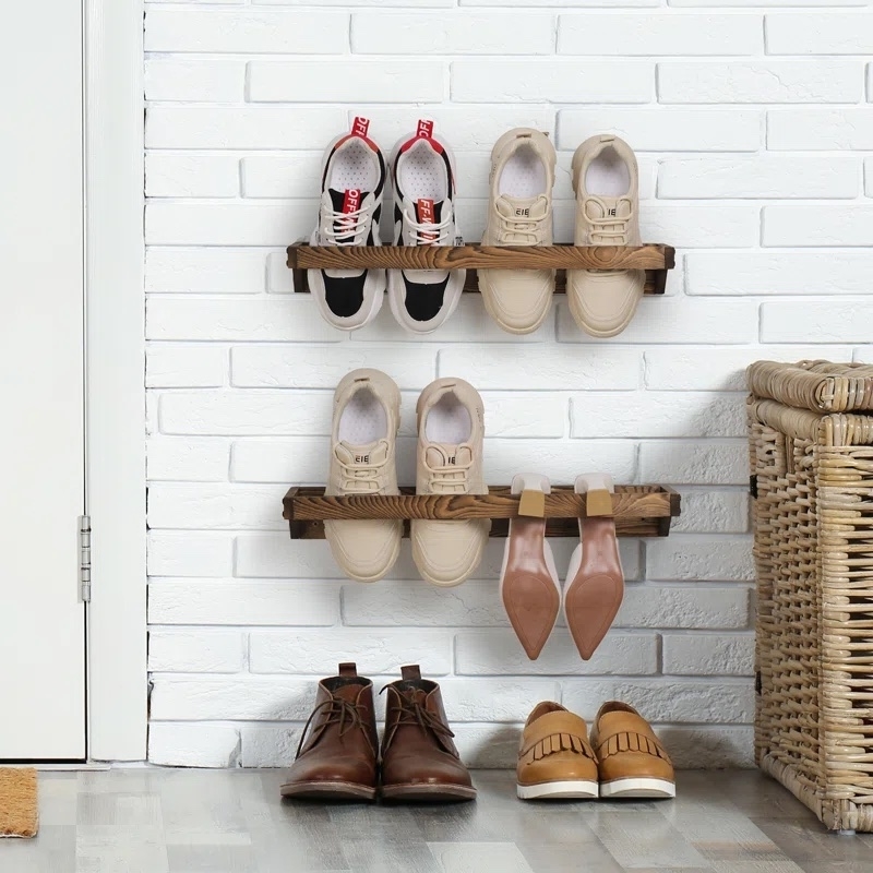shoe rack mounted to wall holding multiple shoes