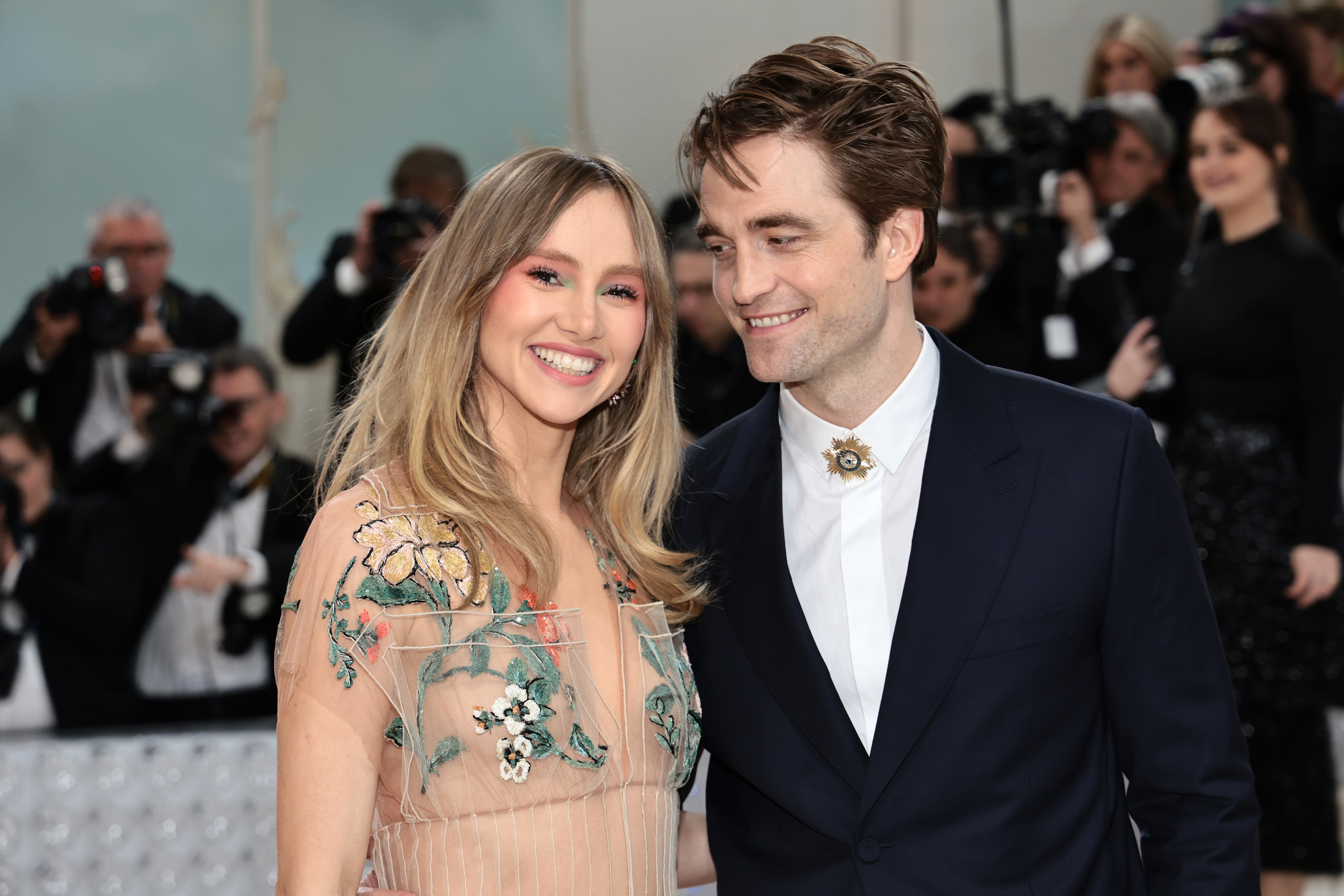 Close-up of Suki and Robert at a media event smiling