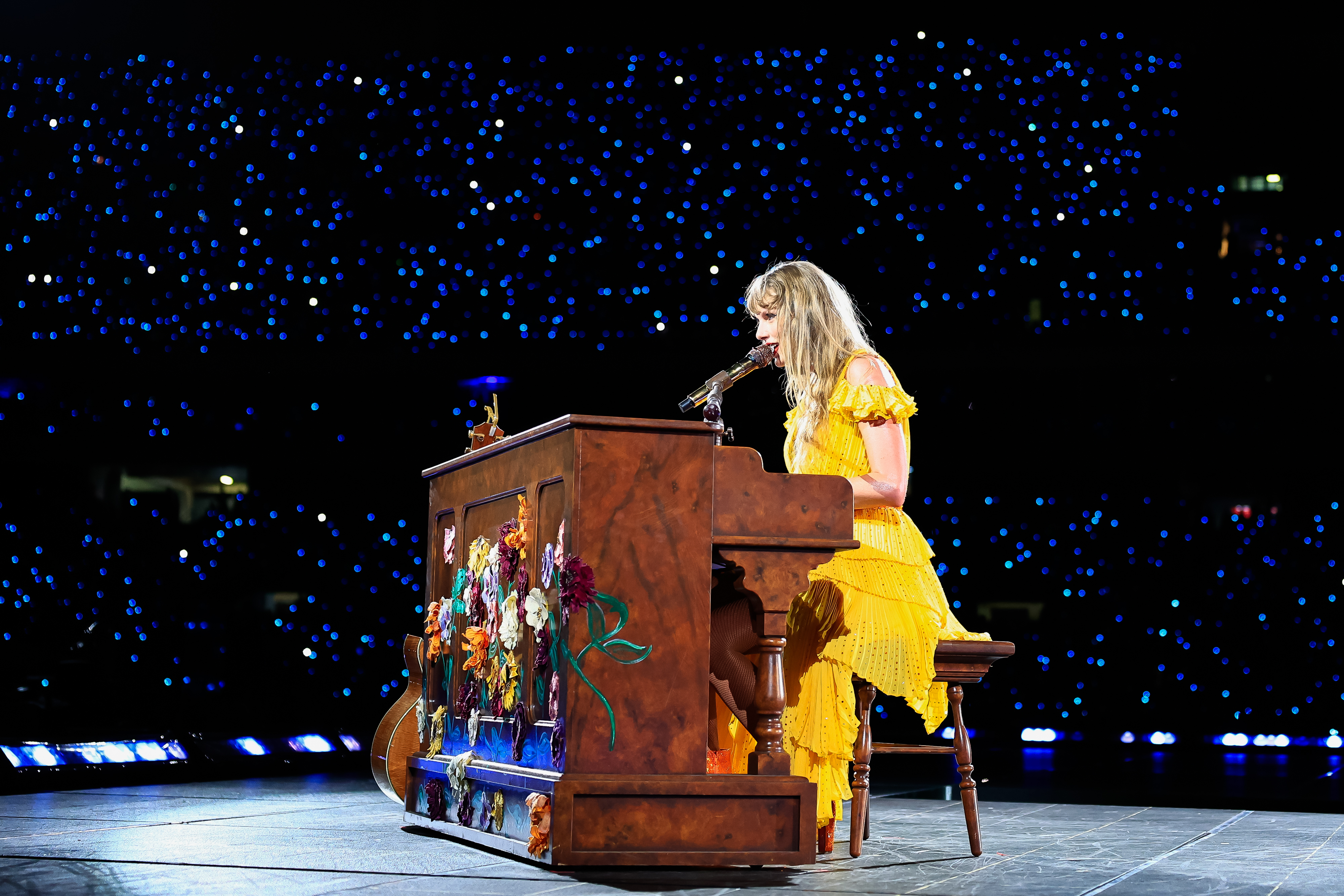 Close-up of Taylor performing onstage at a piano