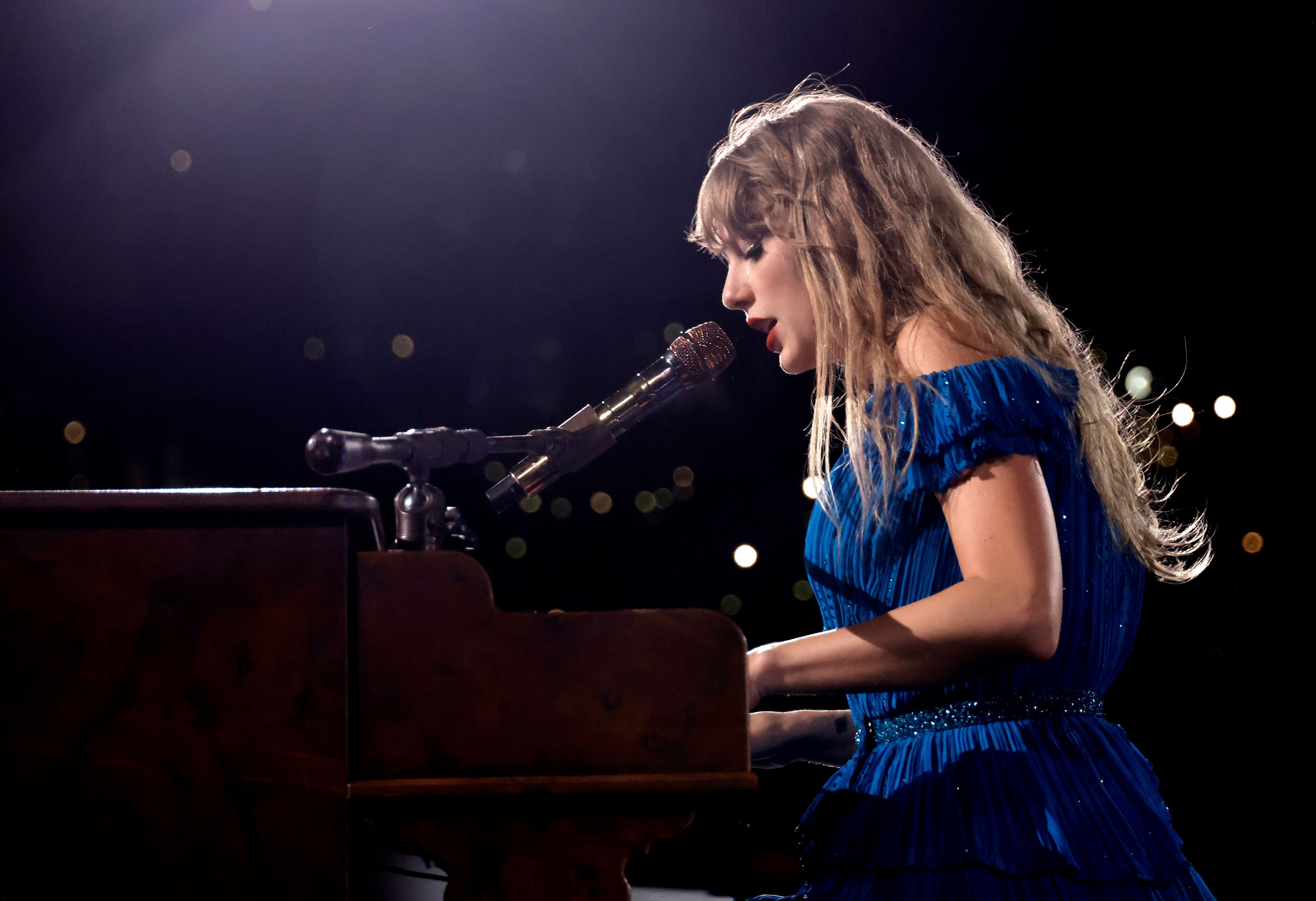 Close-up of Taylor performing onstage at a piano