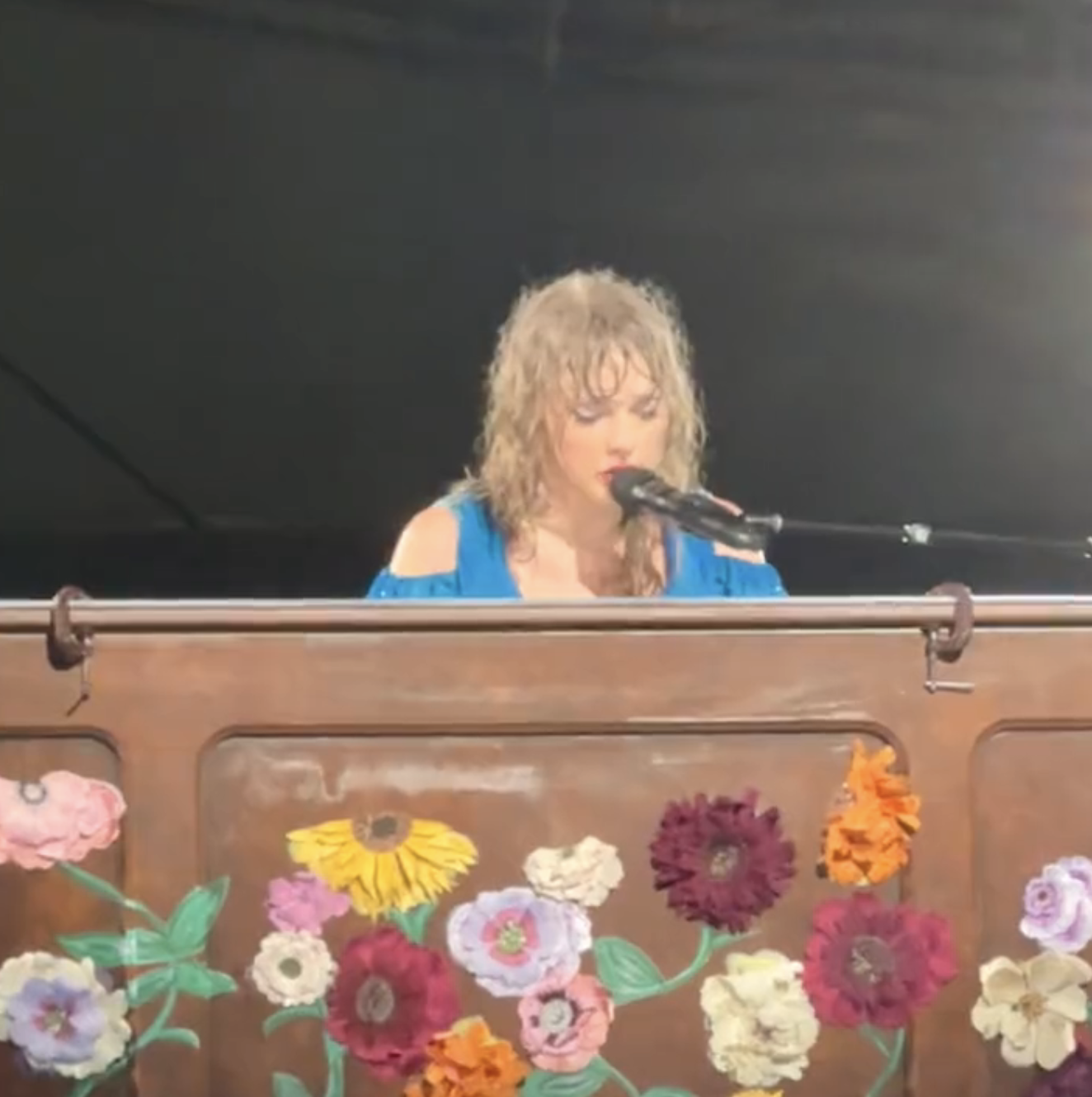 Close-up of Taylor performing onstage at a piano