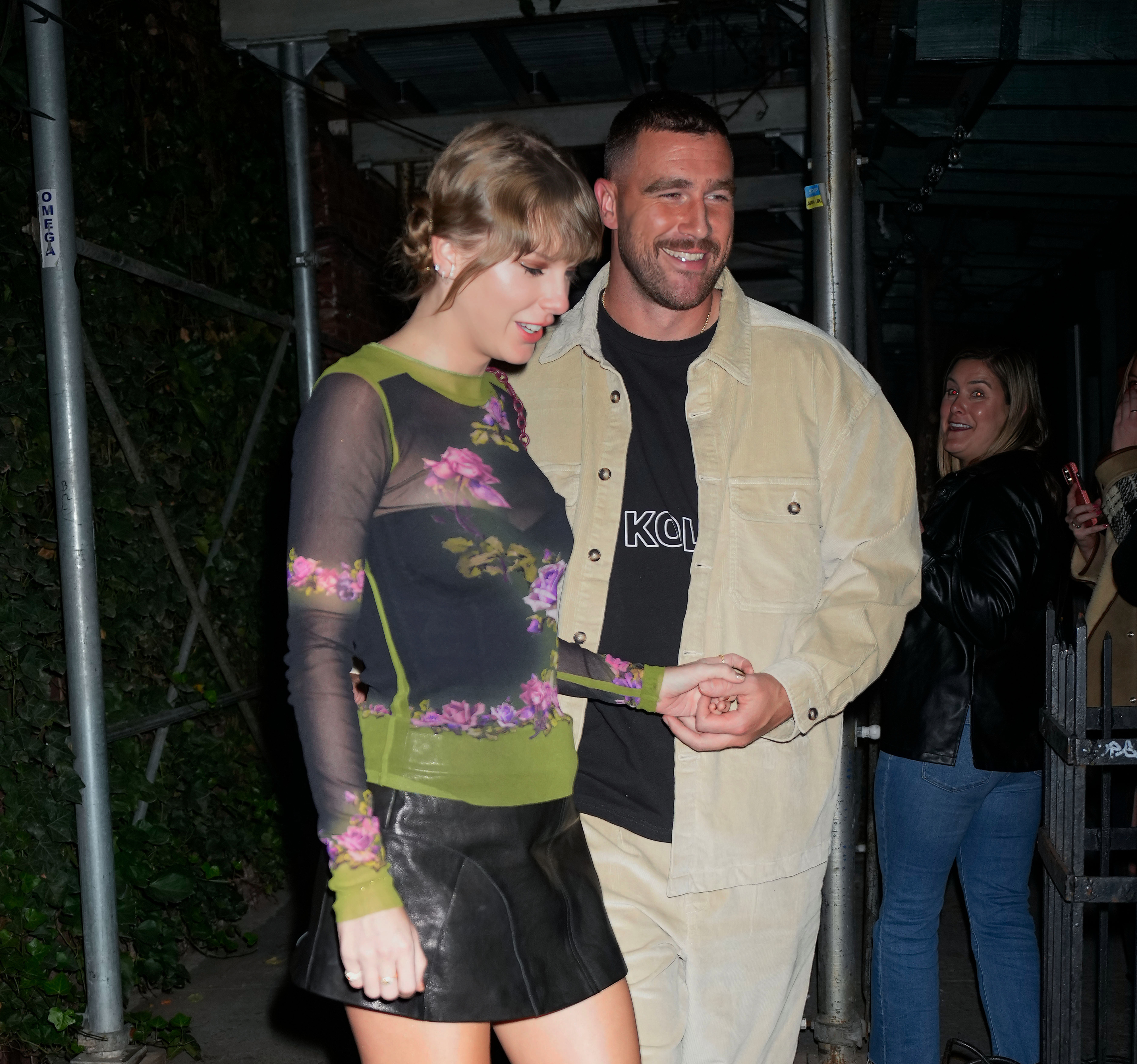 Closeup of Taylor Swift and Travis Kelce holding hands