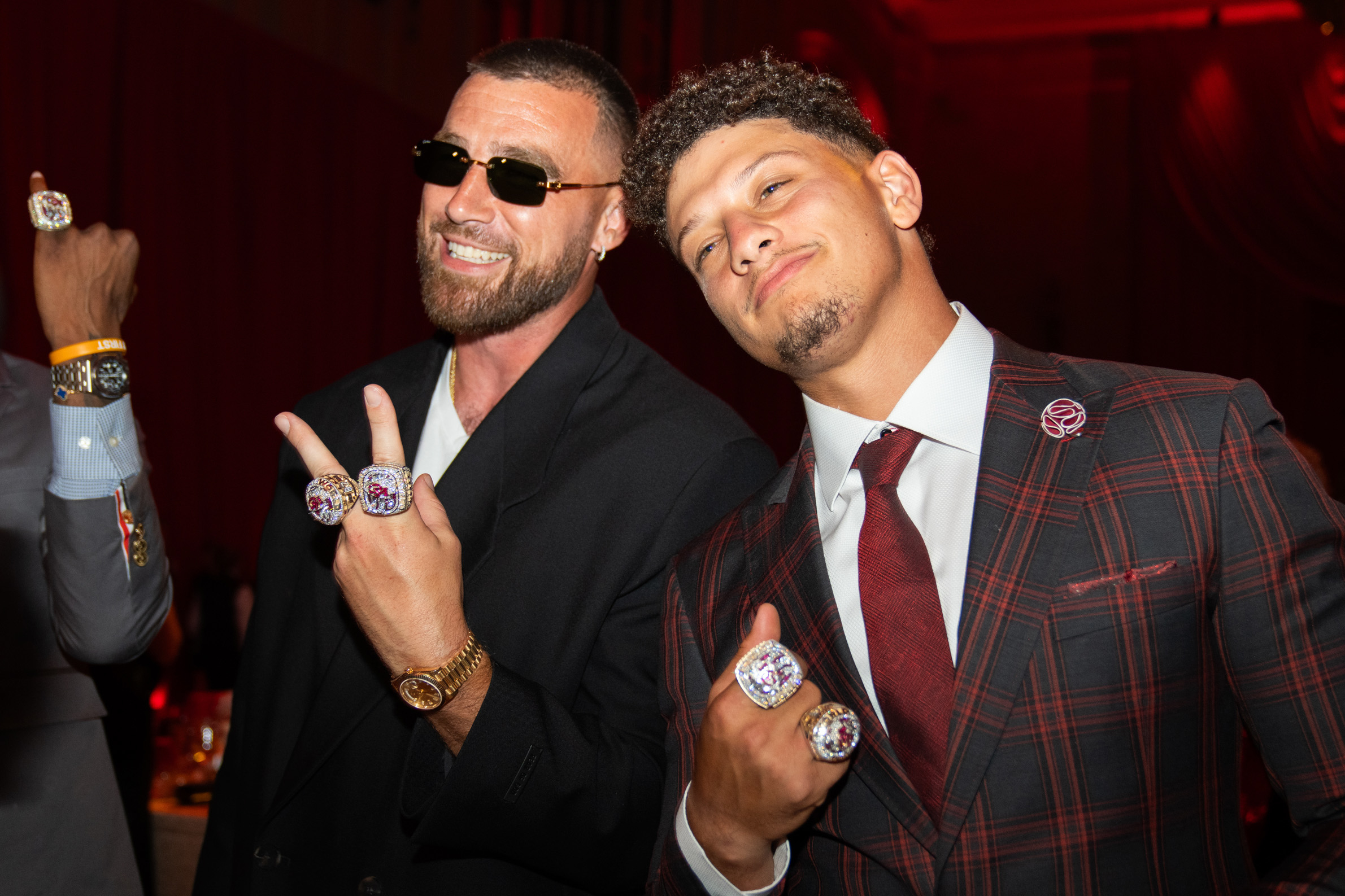 Closeup of Travis Kelce and Patrick Mahomes showing off their championship rings
