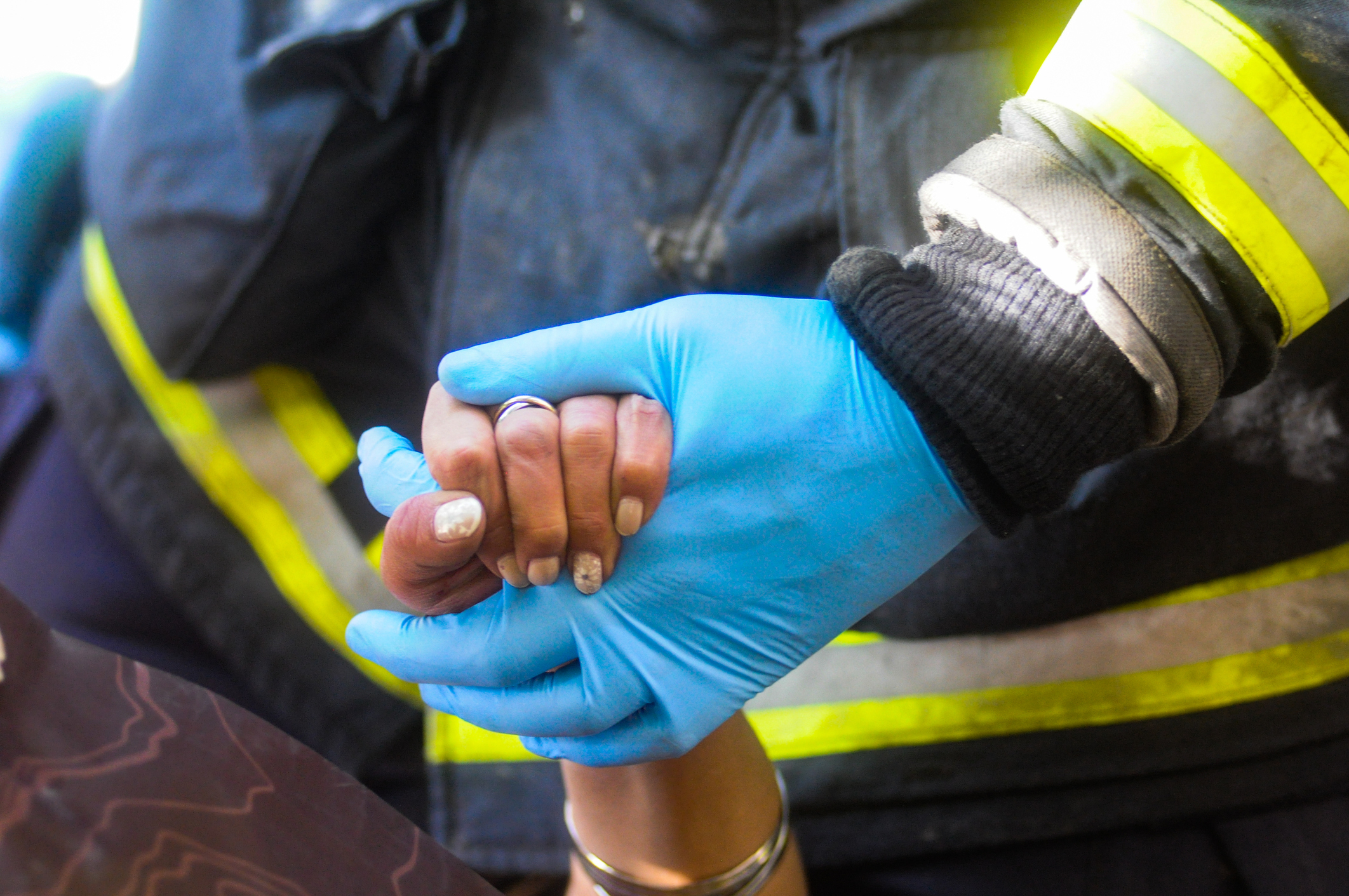 An EMT holding someone&#x27;s hand