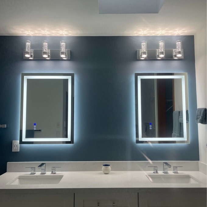 two of the LED mirrors in a reviewer&#x27;s bathroom