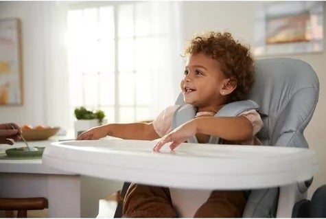 Child sits in a high chair