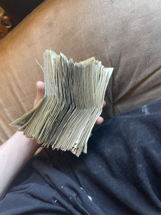 Someone holding a large stack of cash