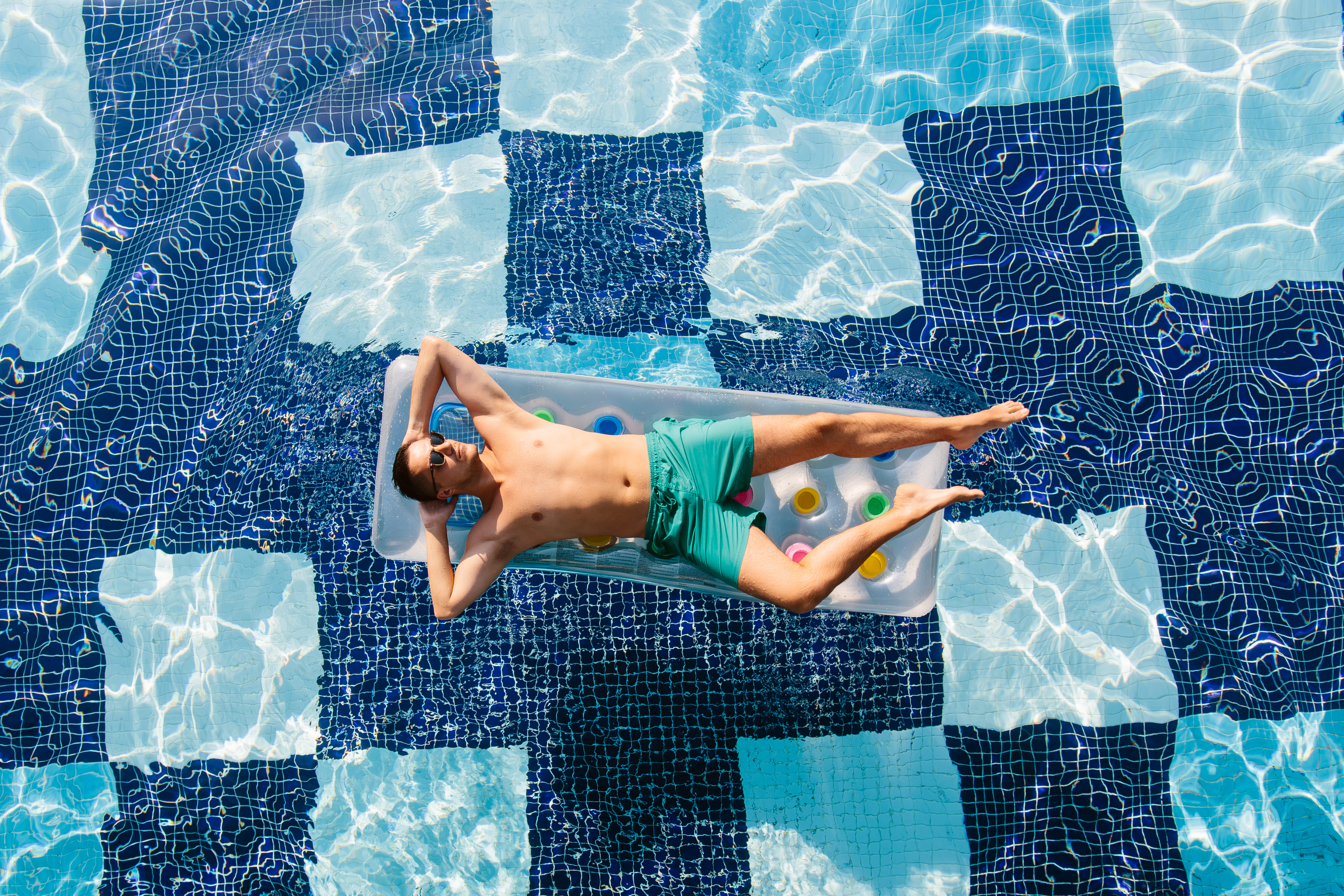 A man floating in the pool