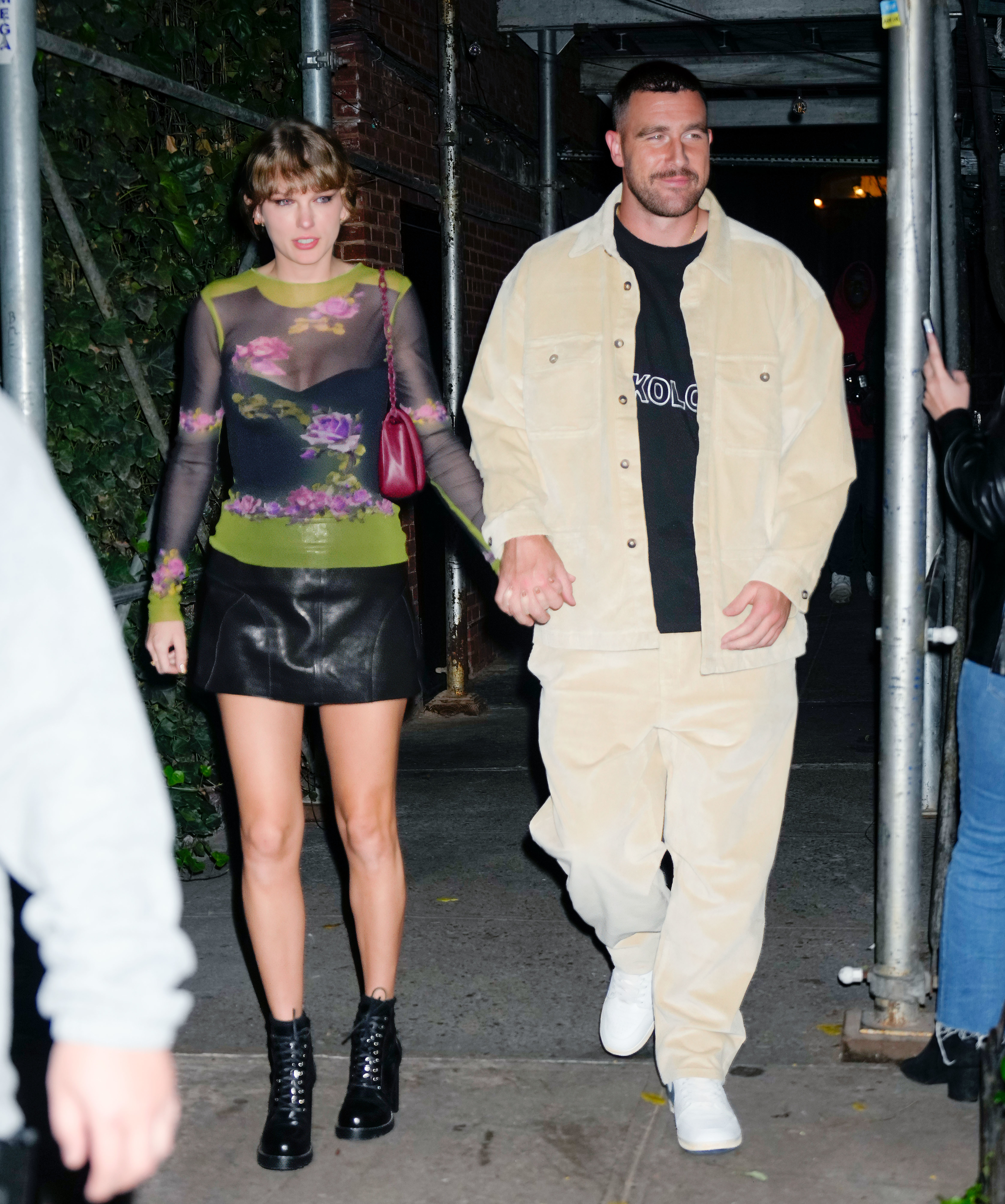 Taylor Swift and Travis Kelce walking hand in hand