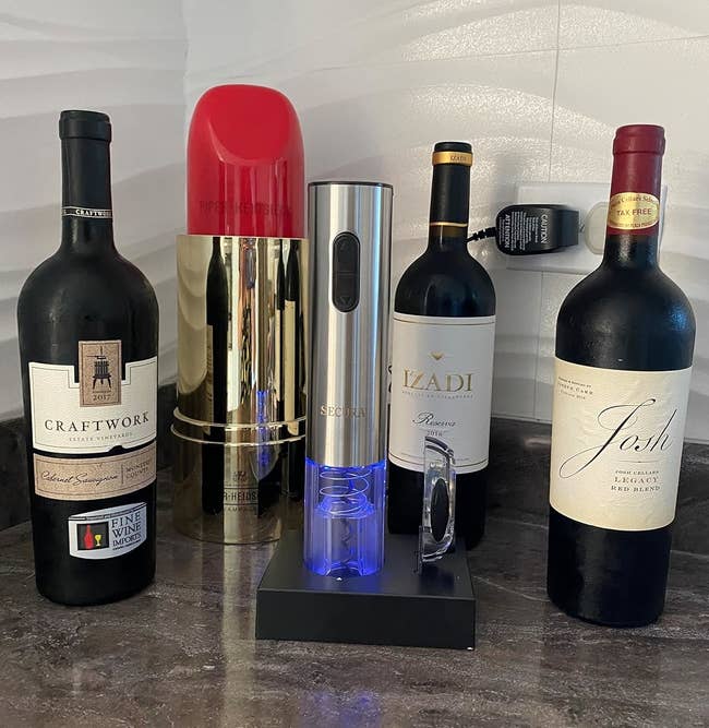 The wine opener surrounded by wine bottles