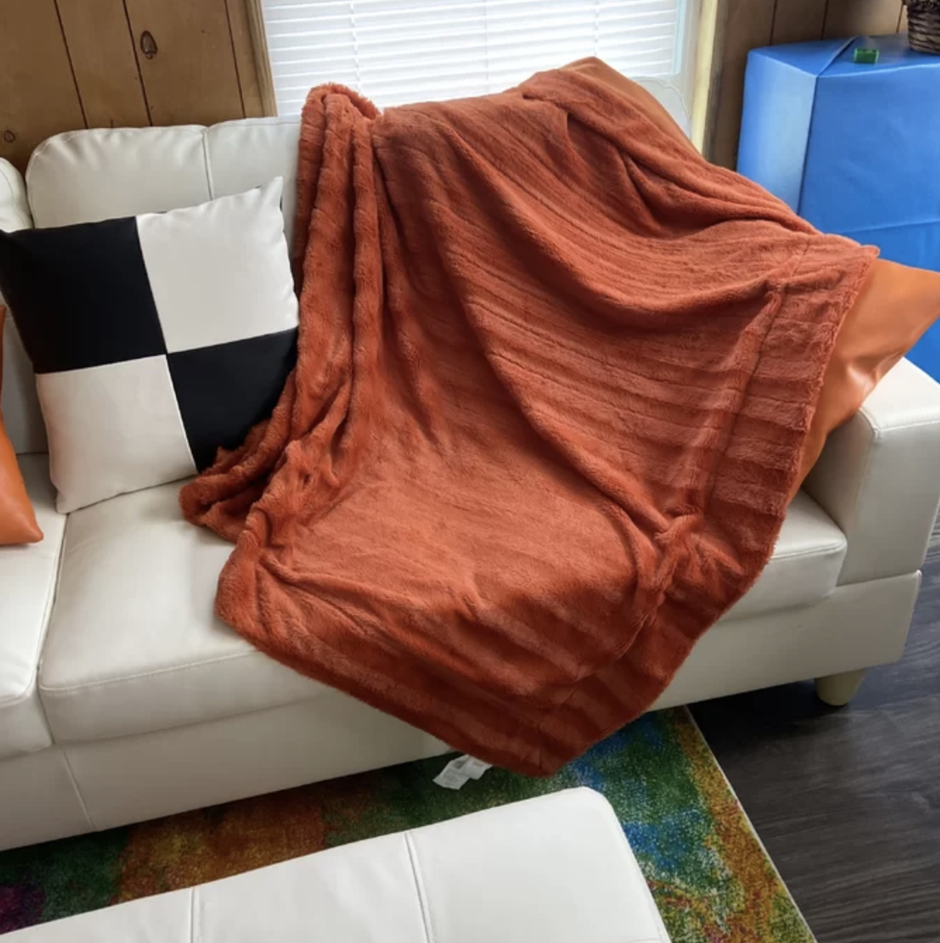 A reviewer&#x27;s orange faux fur blanket