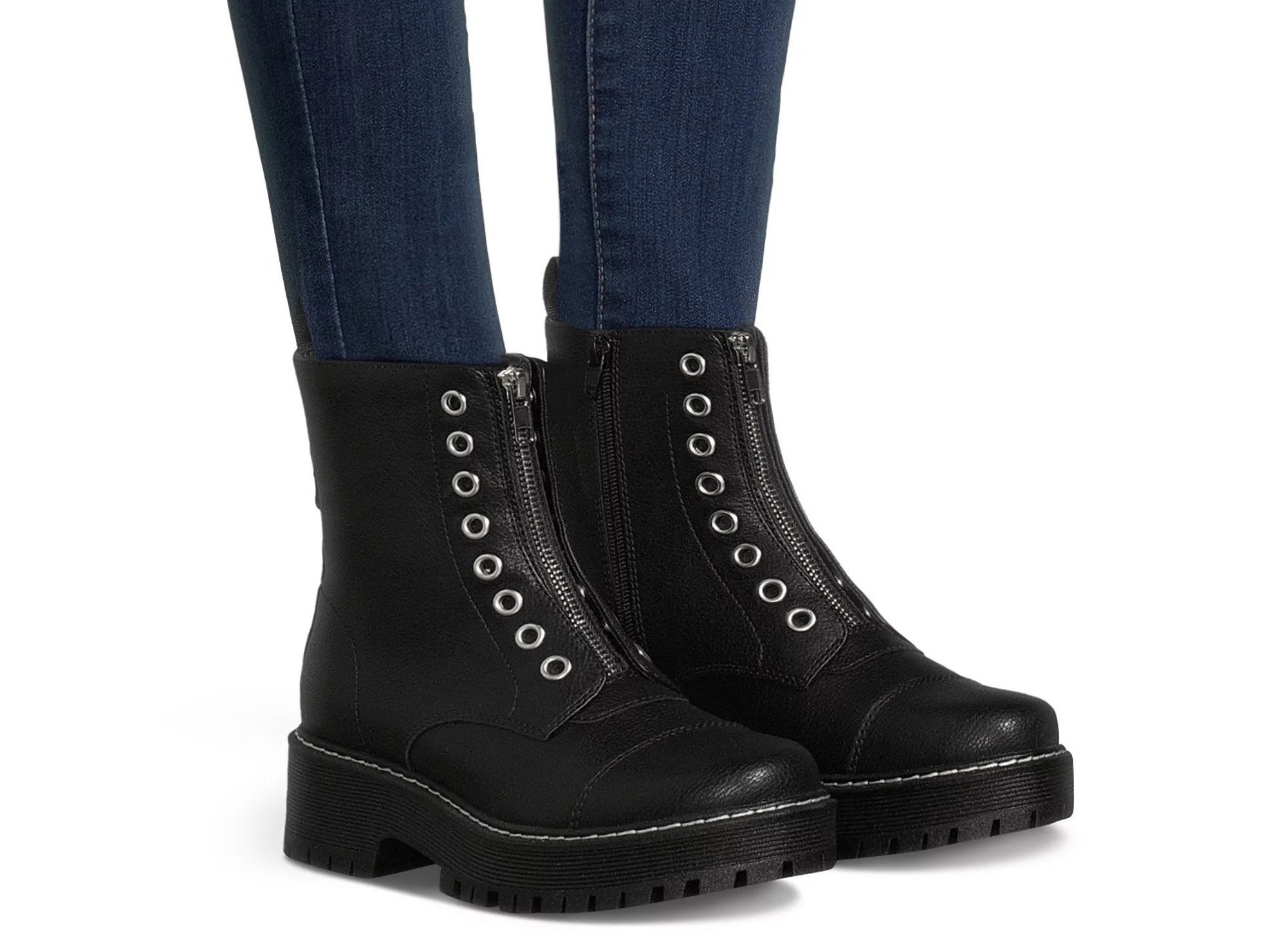The black boots, with grommets and a zipper design in the front, contrast stitching, lug soles, and side zippers