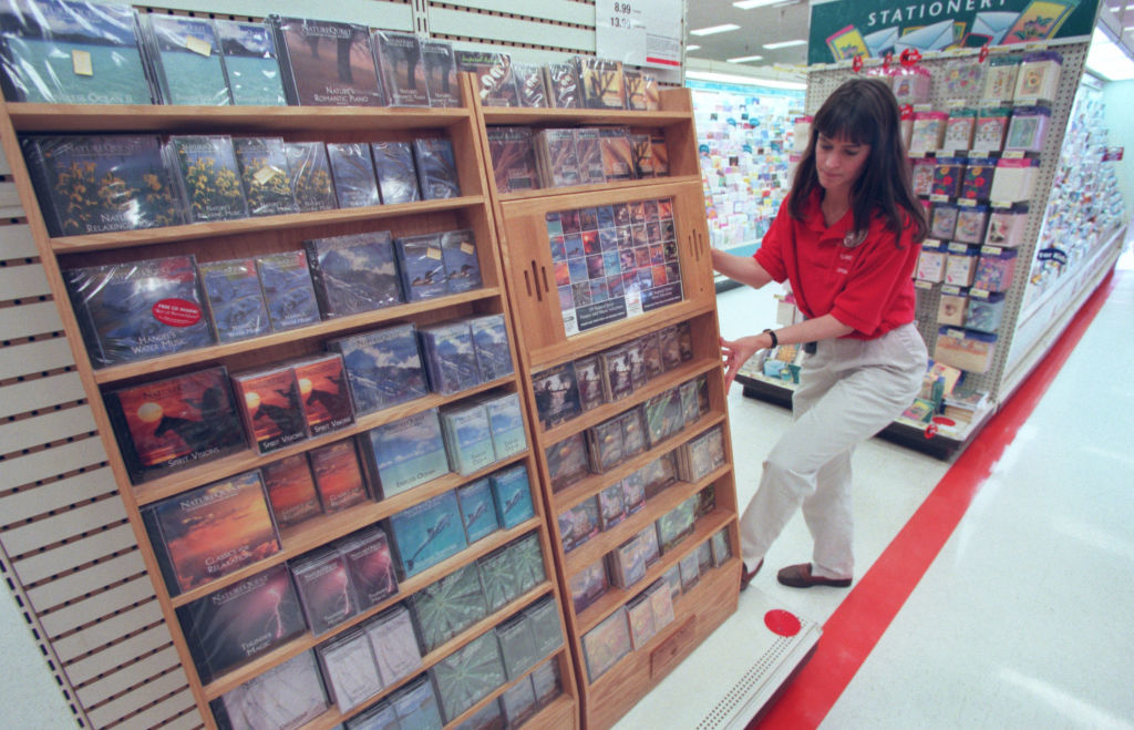 A worker setting up a CD display