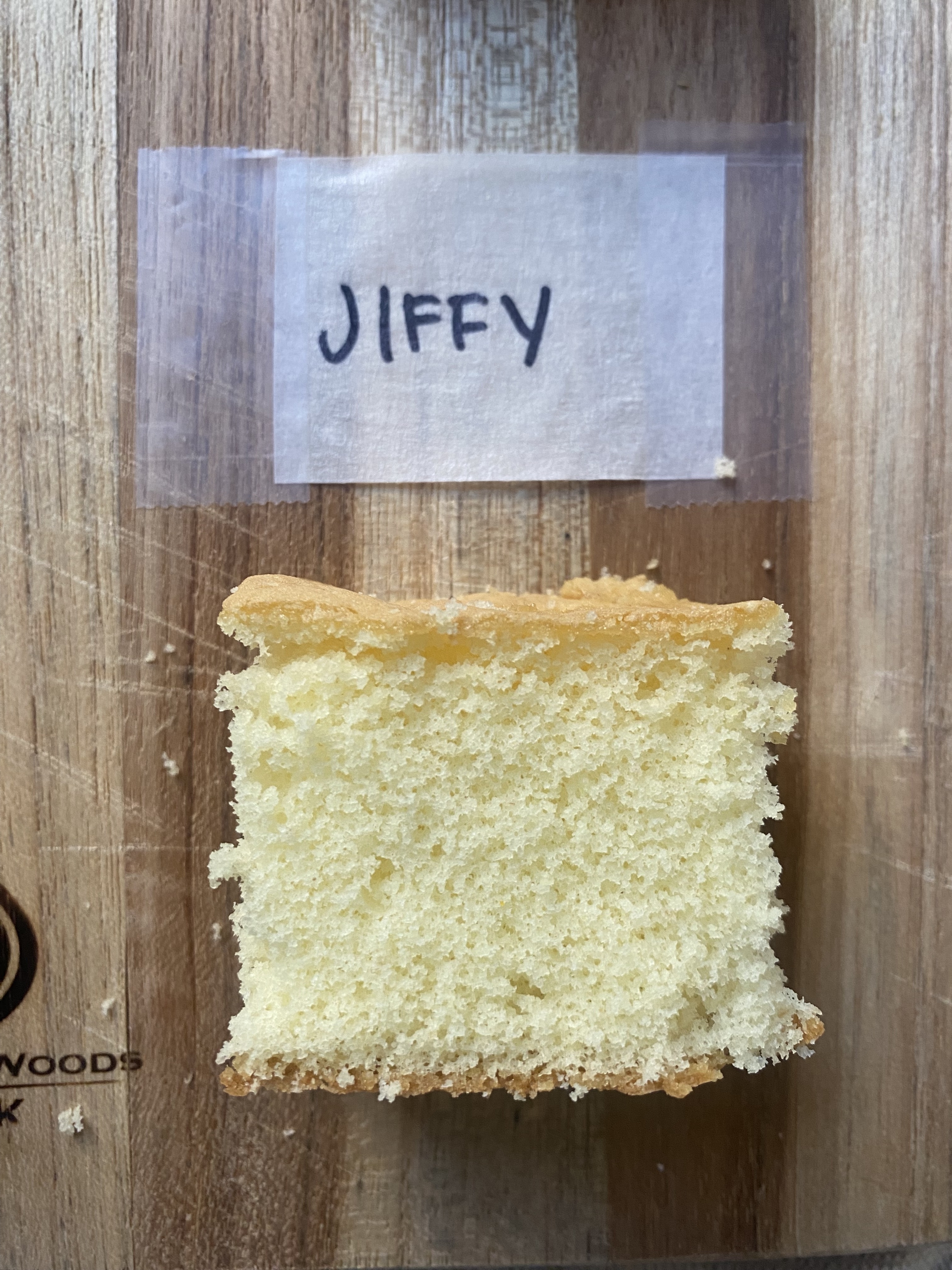 a close-up of a piece of jiffy cake on a cutting board