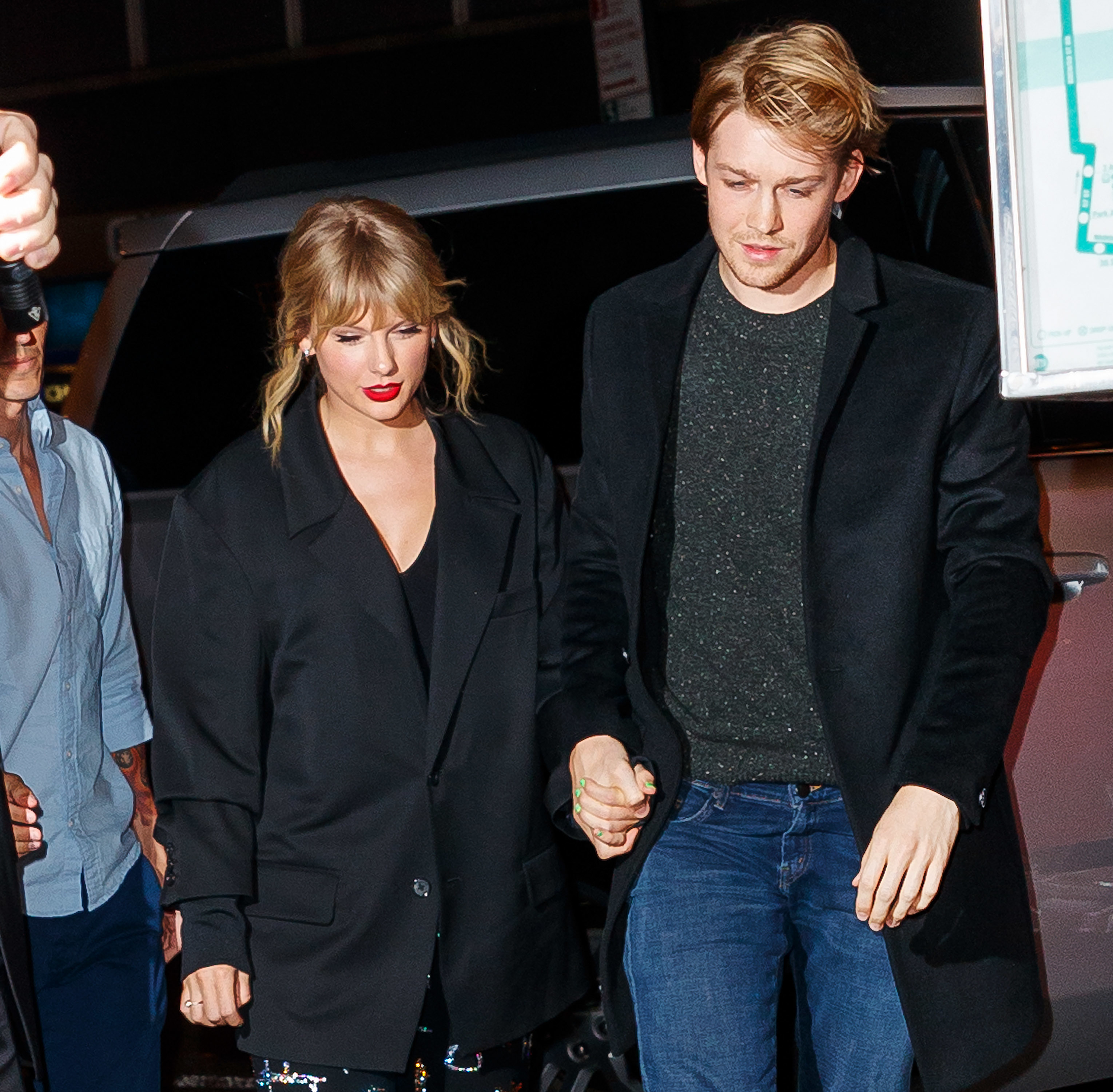 Taylor and Joe holding hands