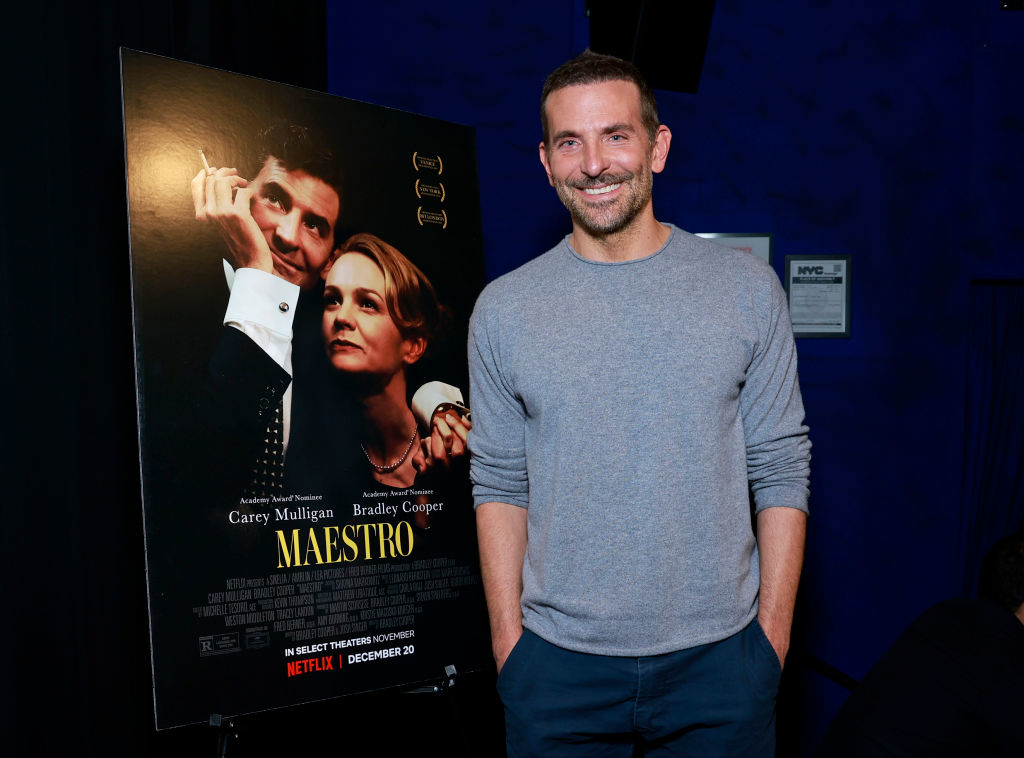 him standing by the movie poster