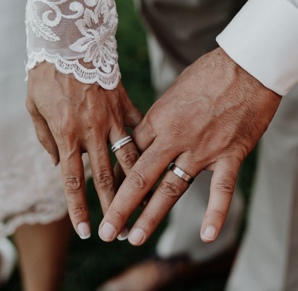 Close-up of newlyweds showing their rings