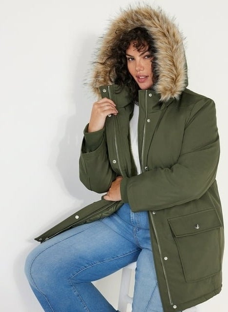 model wearing green hooded winter jacket