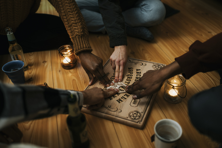 People using a Ouija board