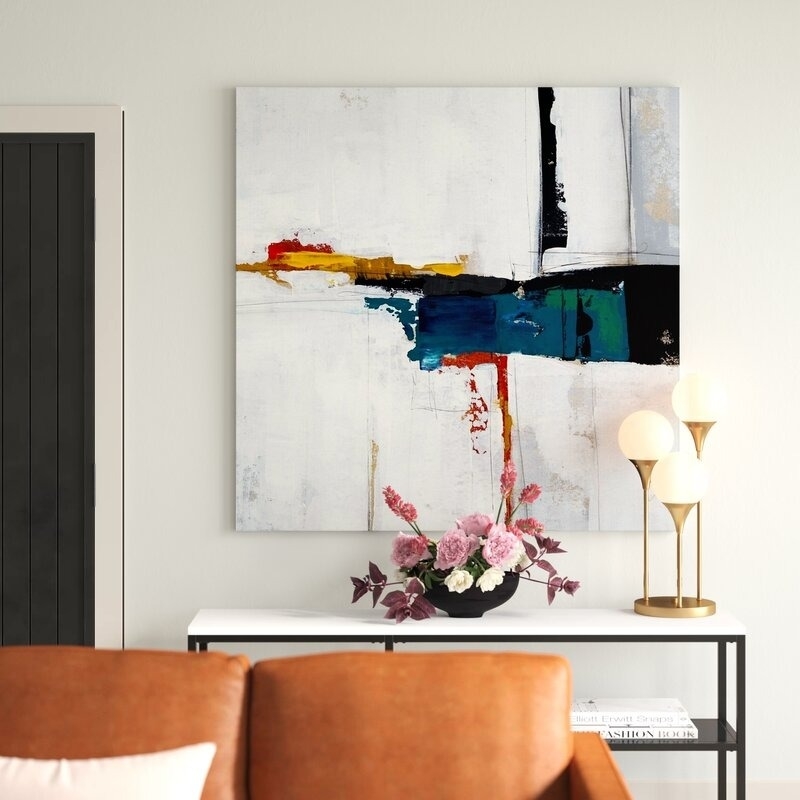 colorful abstract art on square-shaped canvas above narrow table