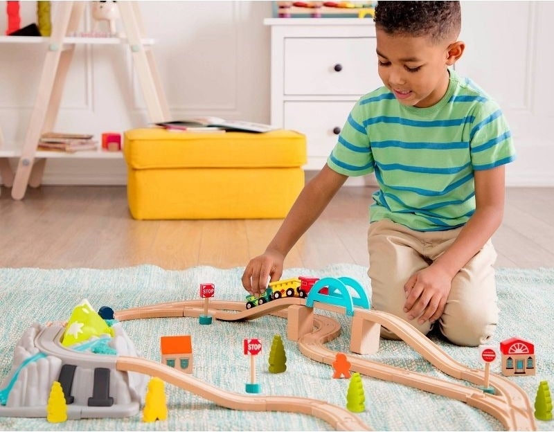 A child plays with a train set