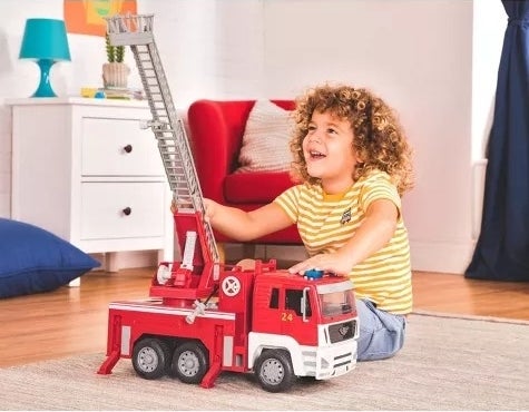A child plays with a toy firetruck