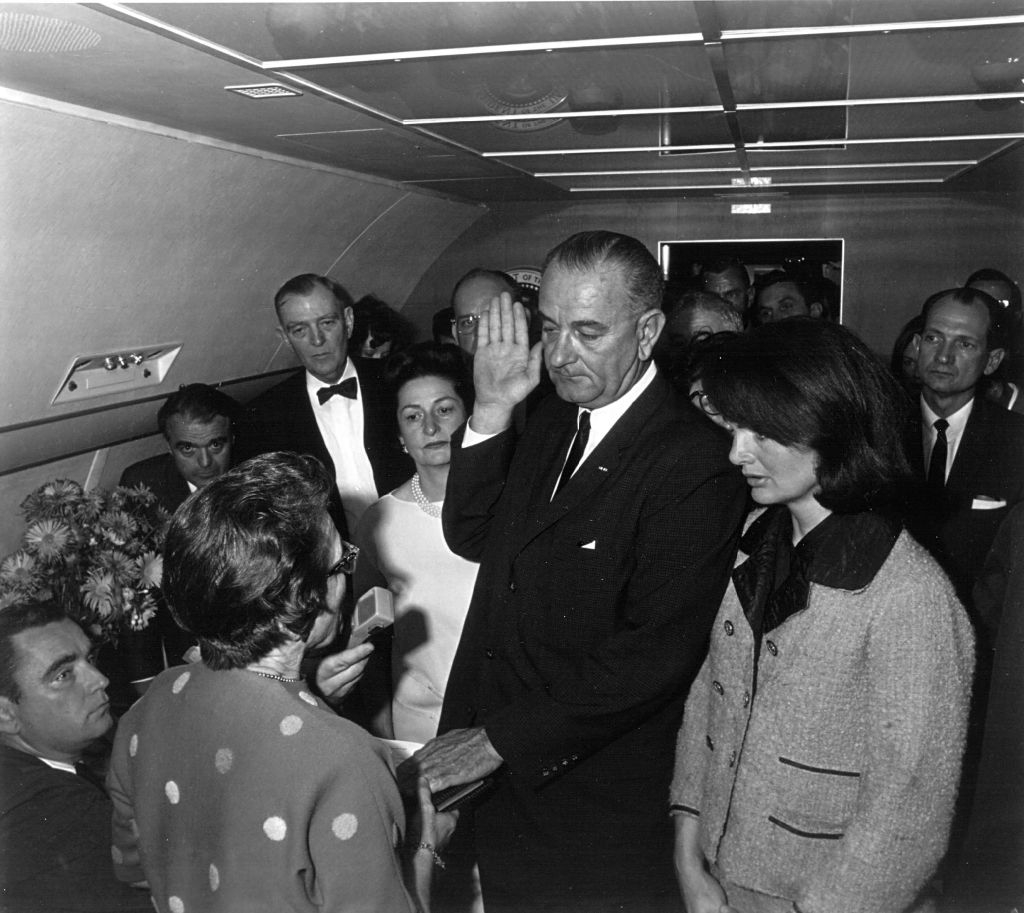Lyndon B. Johnson takes the oath of office as President of the United States
