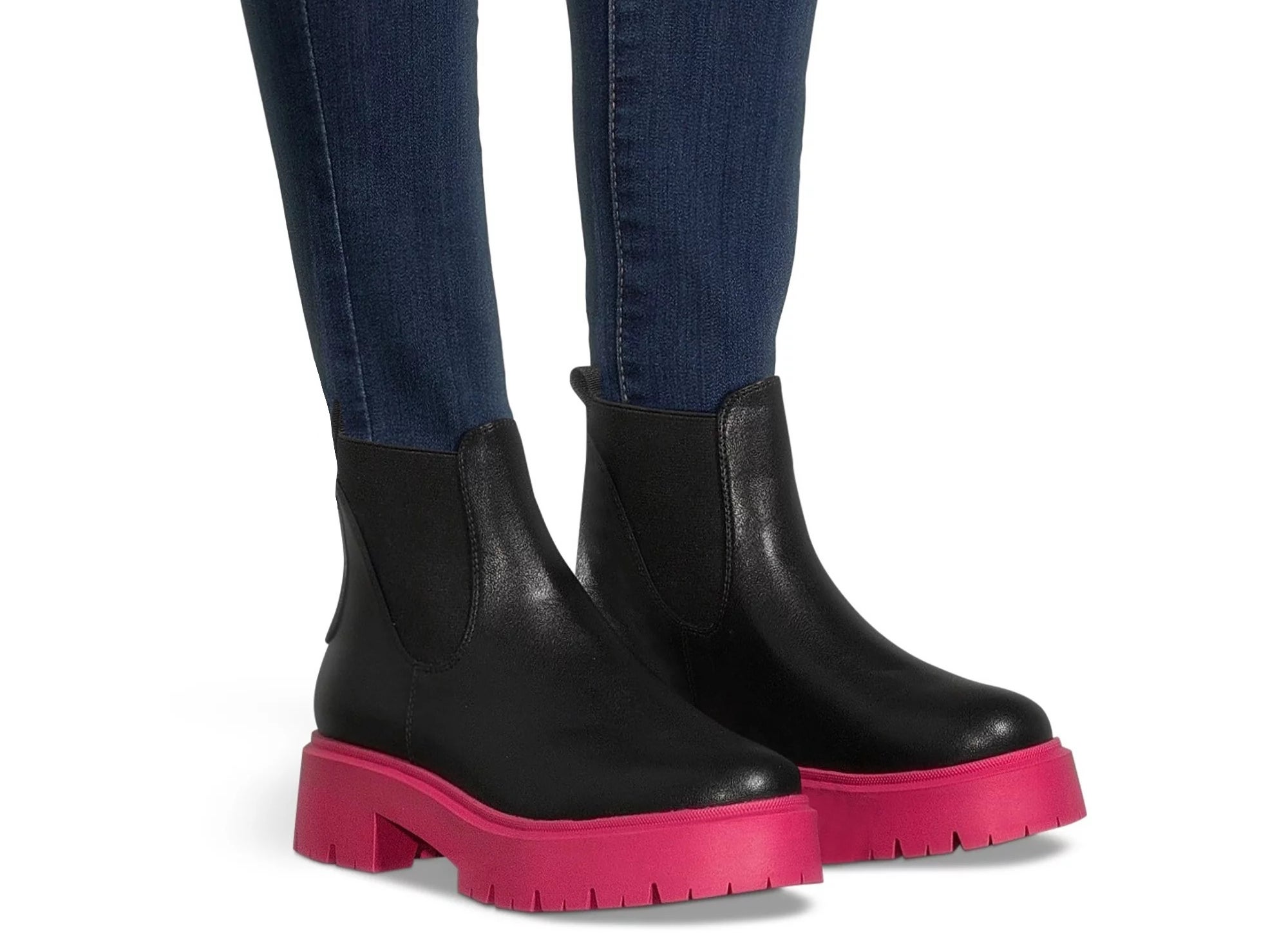 A model wearing the black boots with hot pink soles