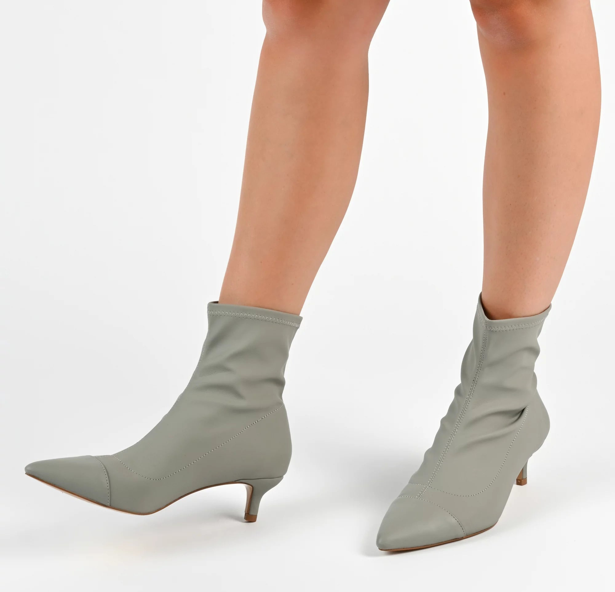 A model wearing the boots in gray