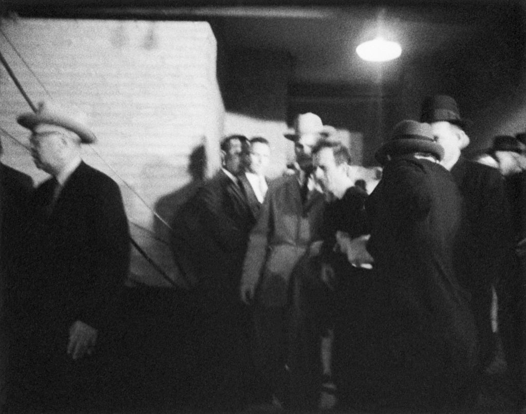 Jack Ruby walks up to accused presidential assassin Lee Harvey Oswald and shoots him as he is escorted into a police station in Dallas