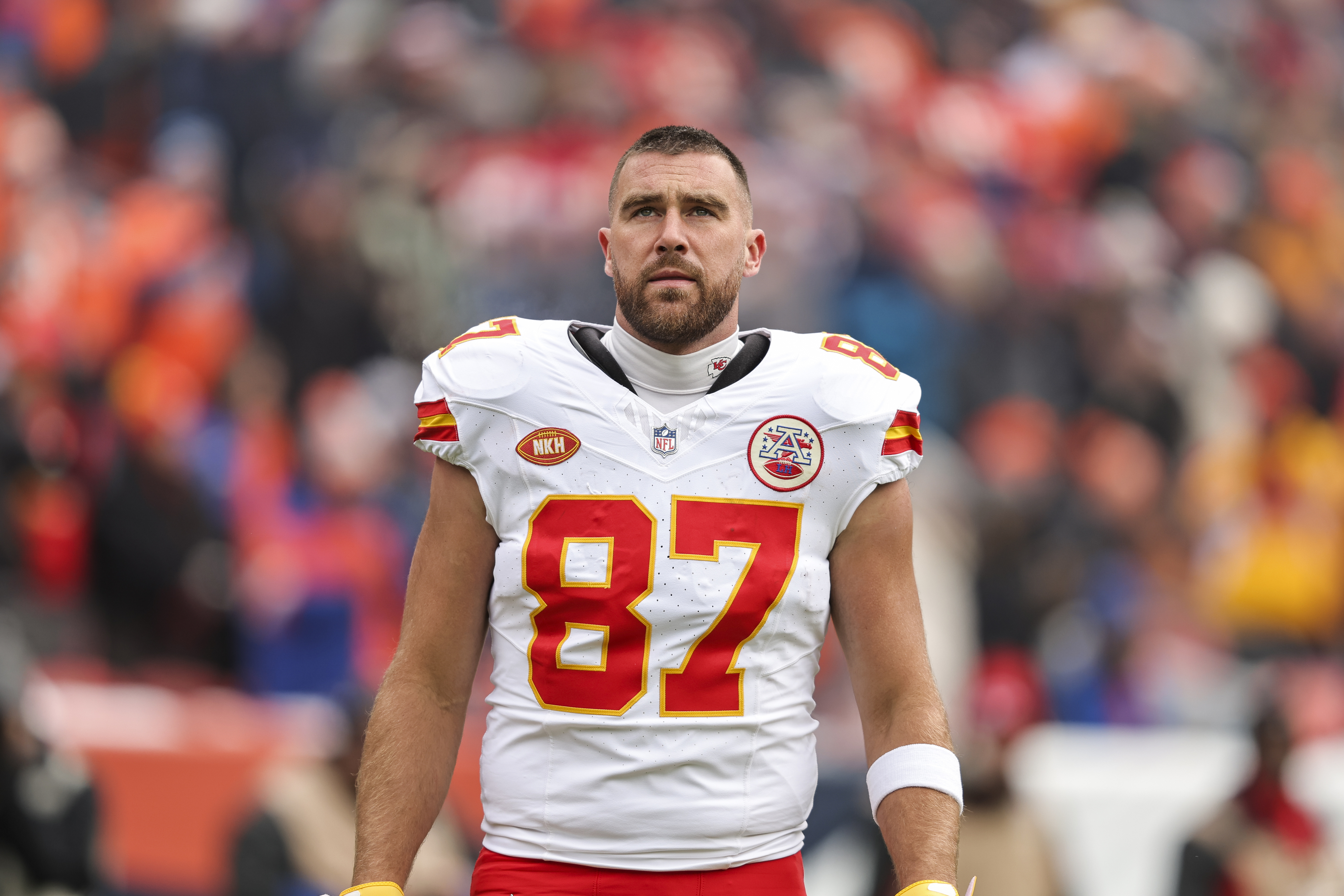 Travis Kelce on the football field without his helmet