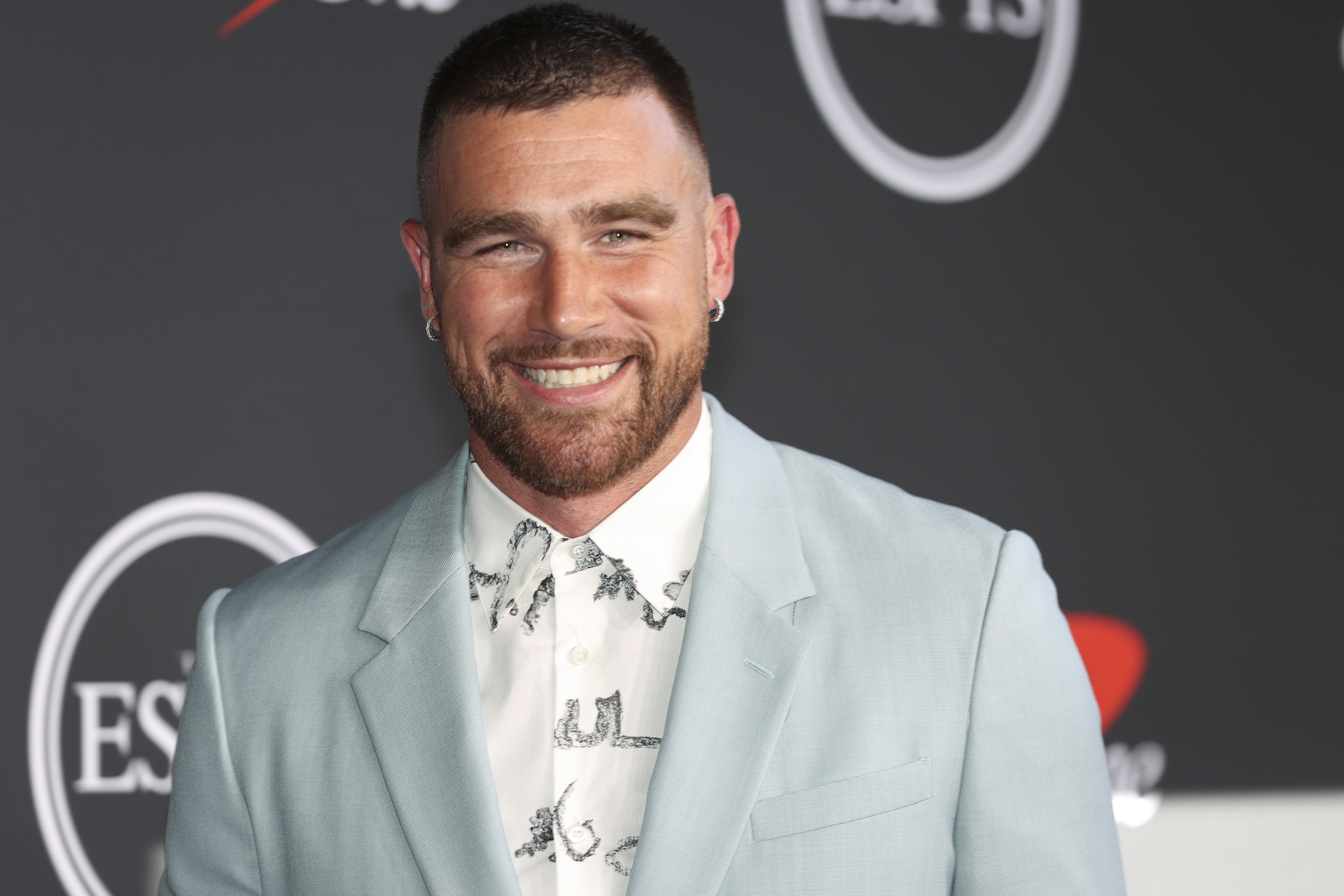 Closeup of Travis Kelce smiling at a media event