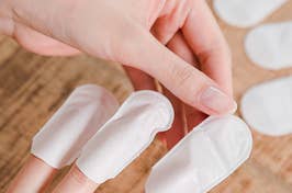 finger sleeves from the nail mask being applied to individual fingernails