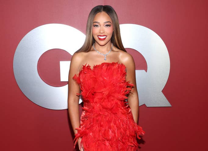 A closeup of Jordyn at a GQ event in a feathered strapless dress