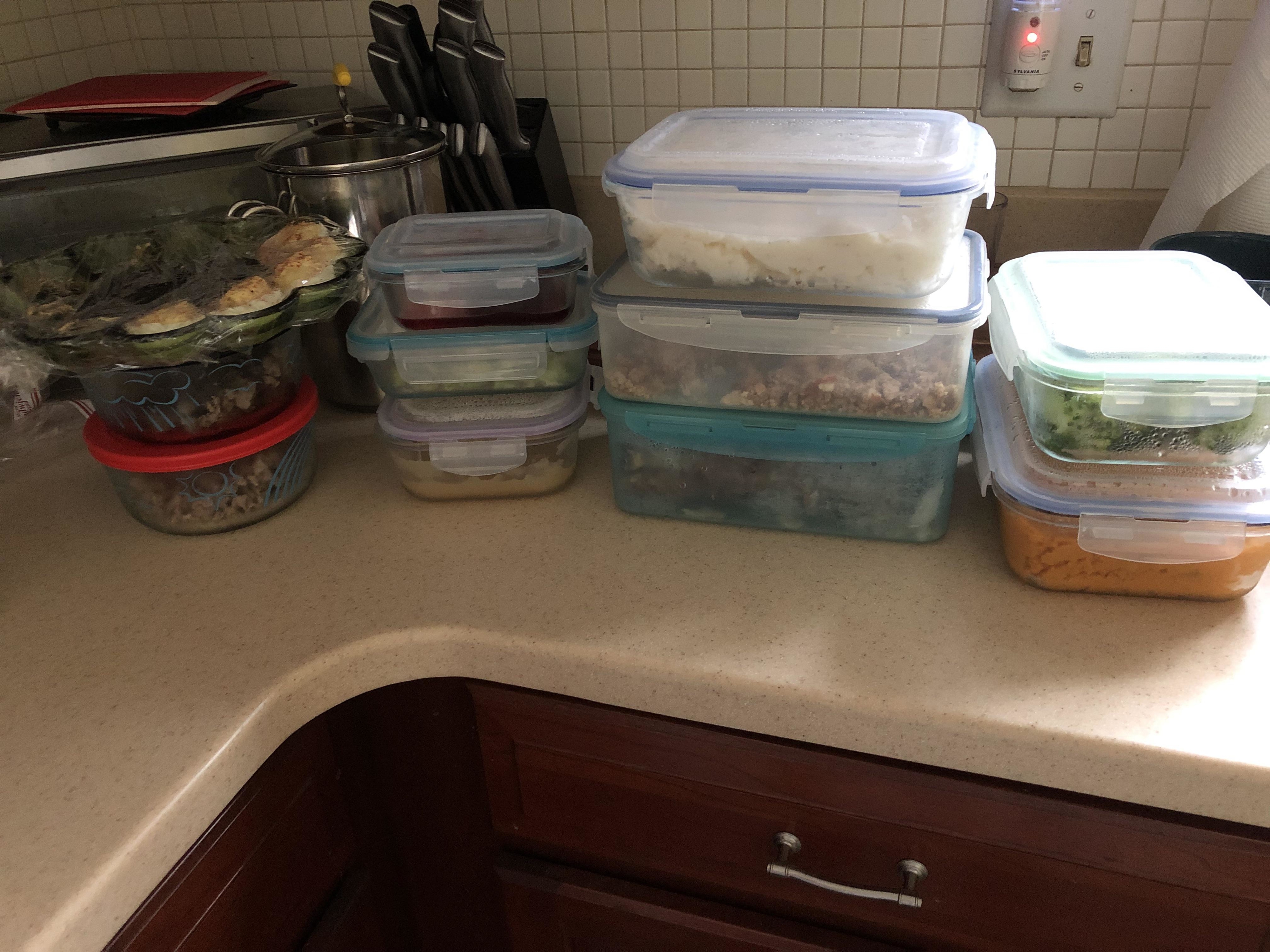 Thanksgiving leftovers in plastic containers on a kitchen counter