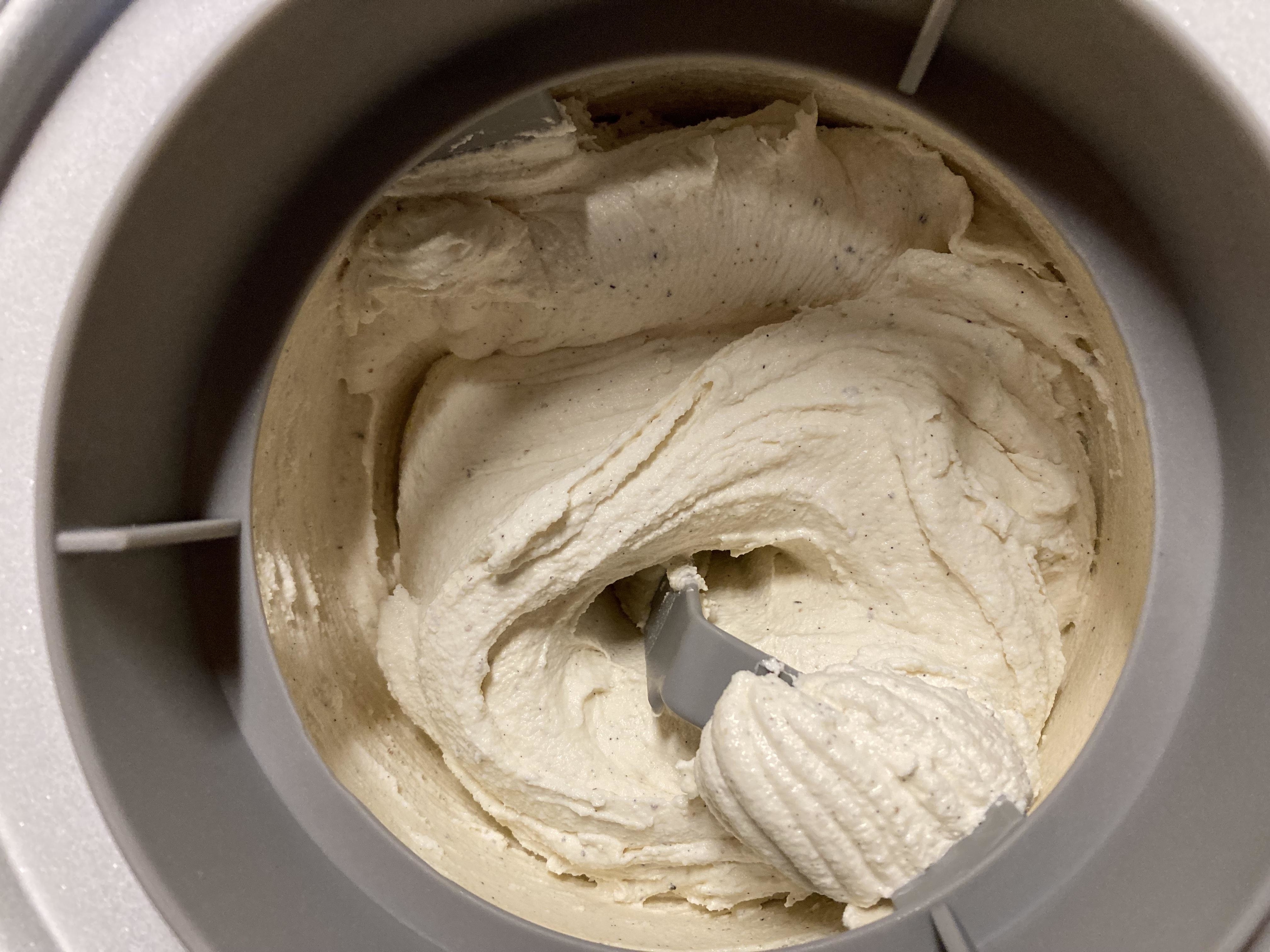 Homemade ice cream in ice cream–maker, churning