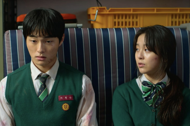 A man and a woman in school uniforms look into one another's eyes
