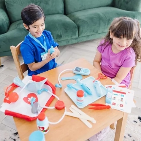 Kids playing with a doctor kit