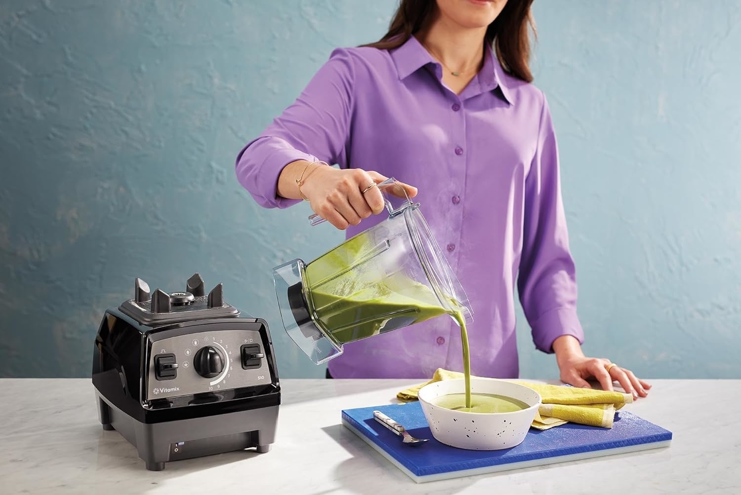 model pouring soup from a blender