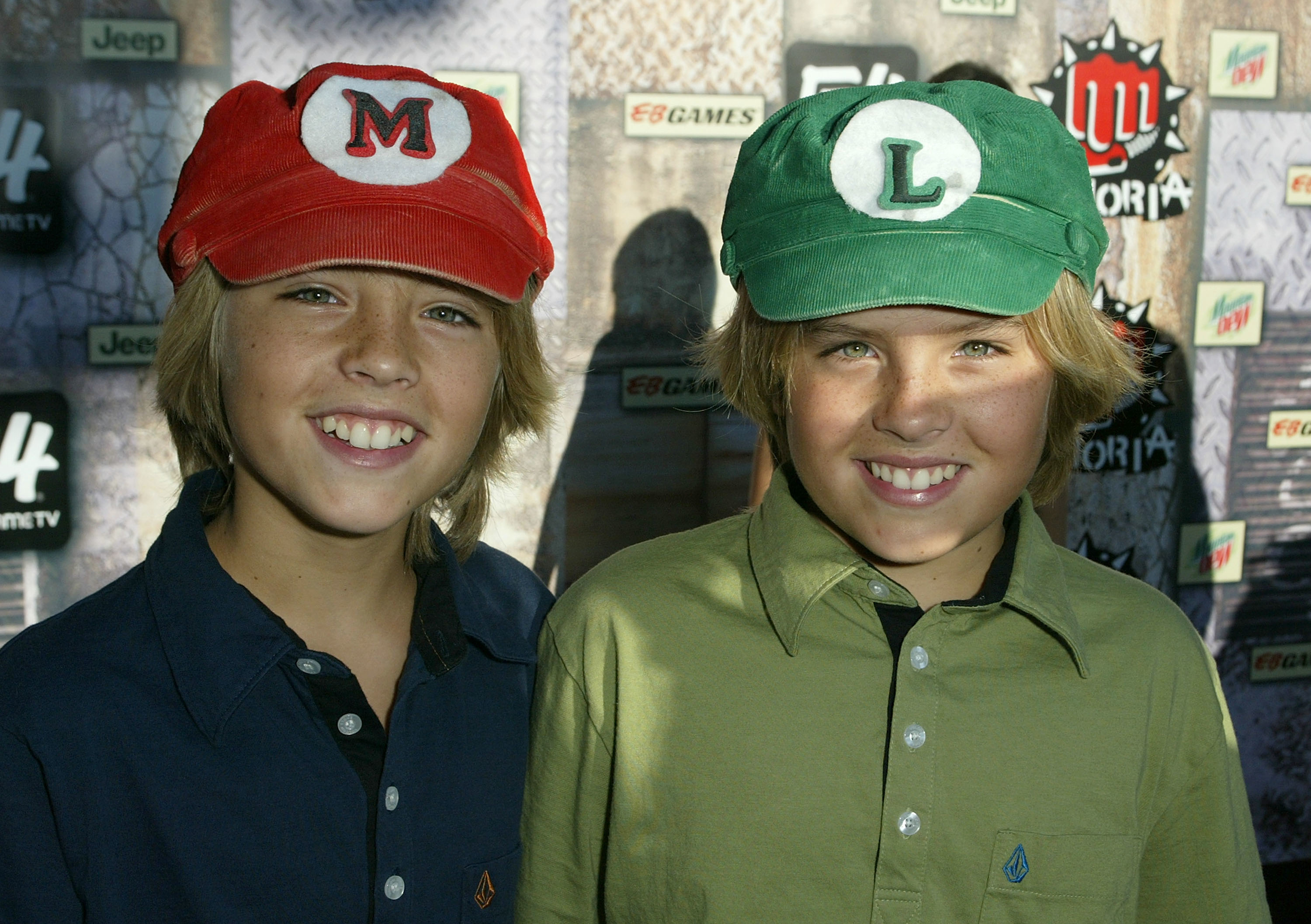 closeup of the twins wearing mario and luigi hats