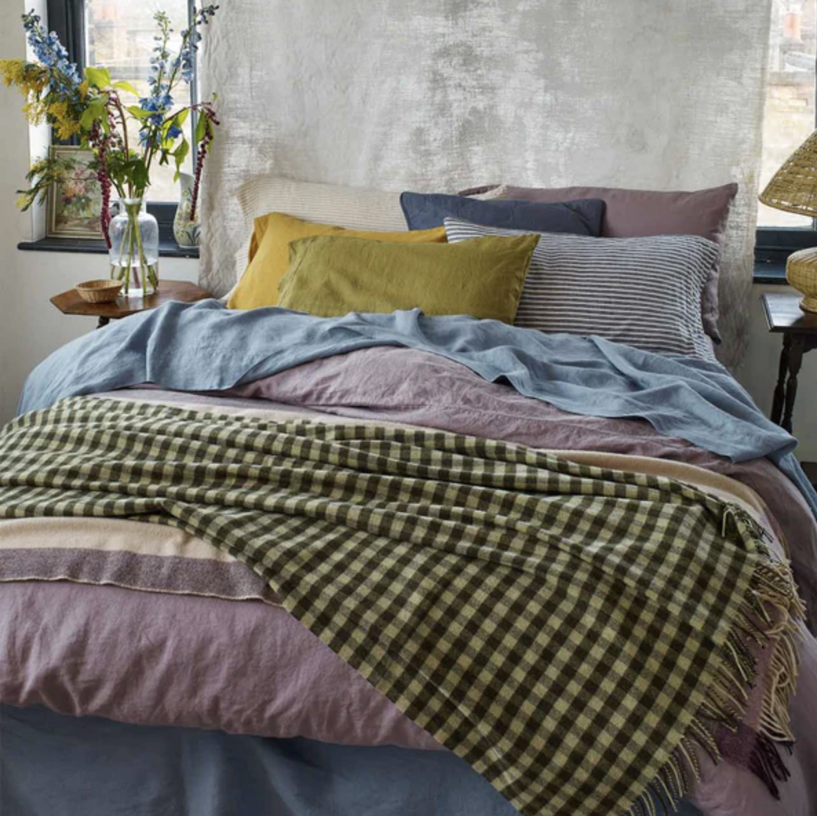 mix-and-match linen bedding in greens, purples, and blues