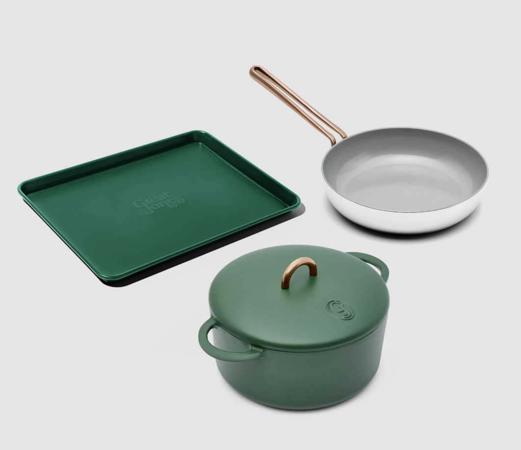 a green sheet pan, a green pot, and a white frying pan