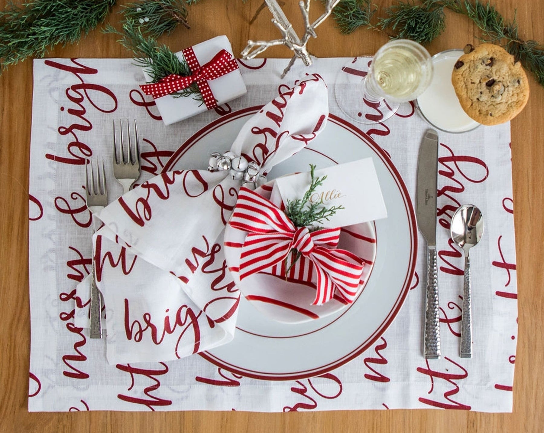 a white place mat that says merry &amp;amp; bright on it in red script letters