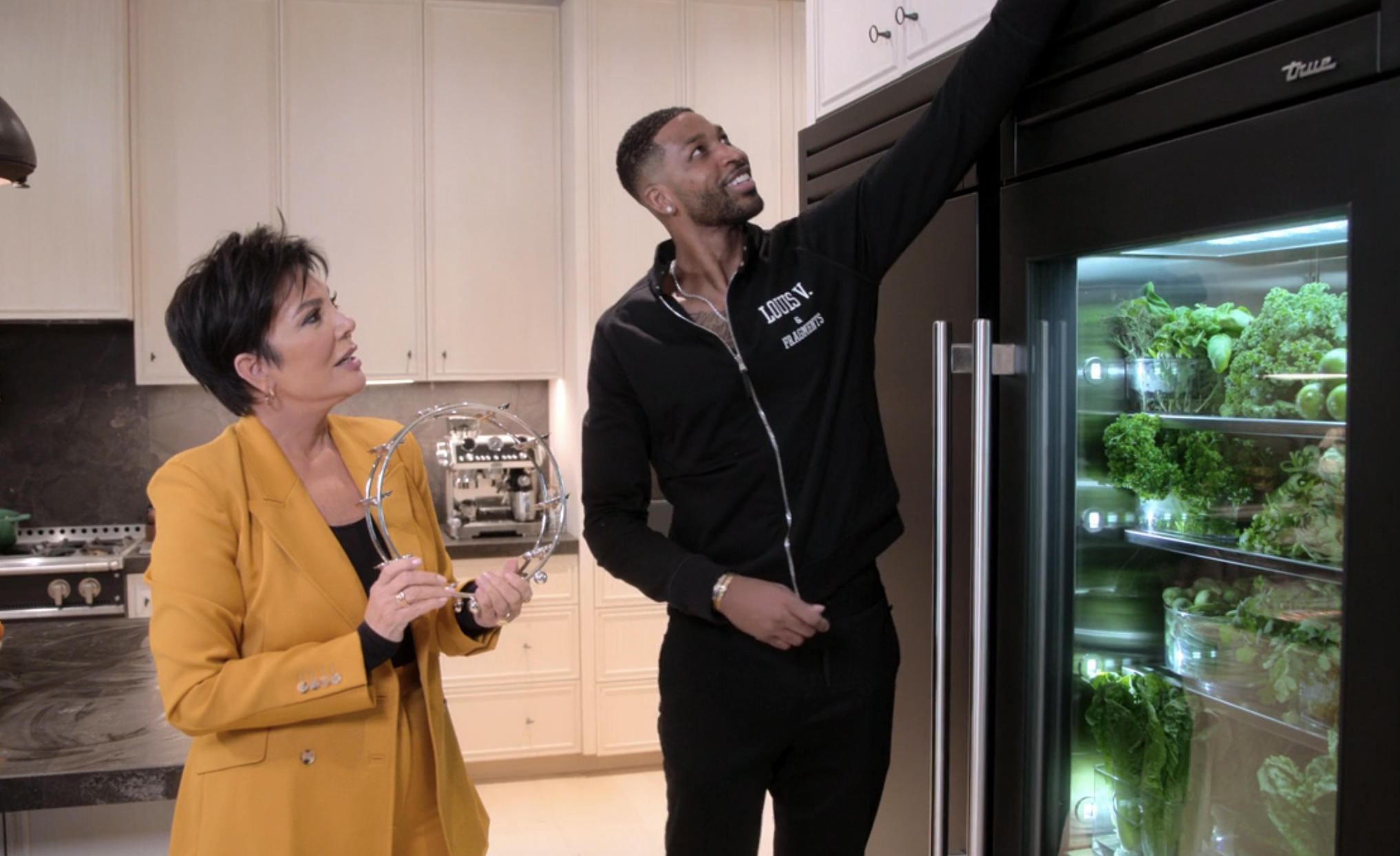 tristan reaching for something high for kris jenner in the kitchen