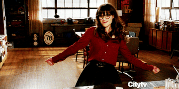 Jess from The New Girl dancing excitedly