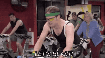 Dwight from The Office peddling vigorously in a cycling class with the caption &quot;let&#x27;s blast&quot;