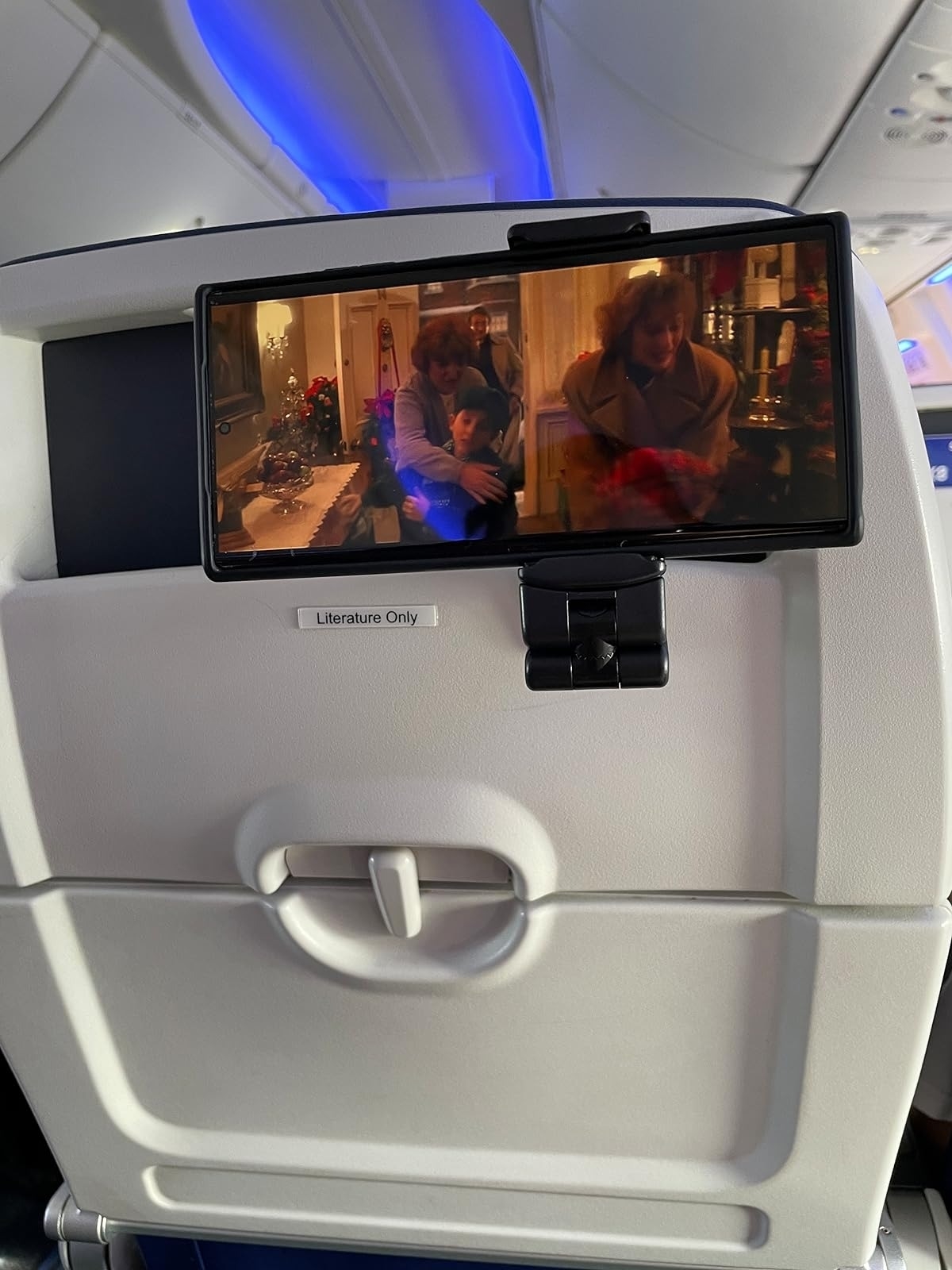 reviewer image of a smartphone attached to the upright seat table on a plane