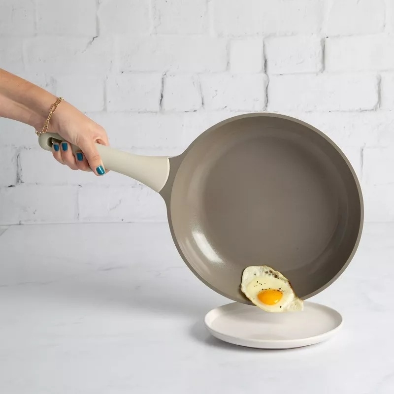 the pan pouring an egg onto a plate