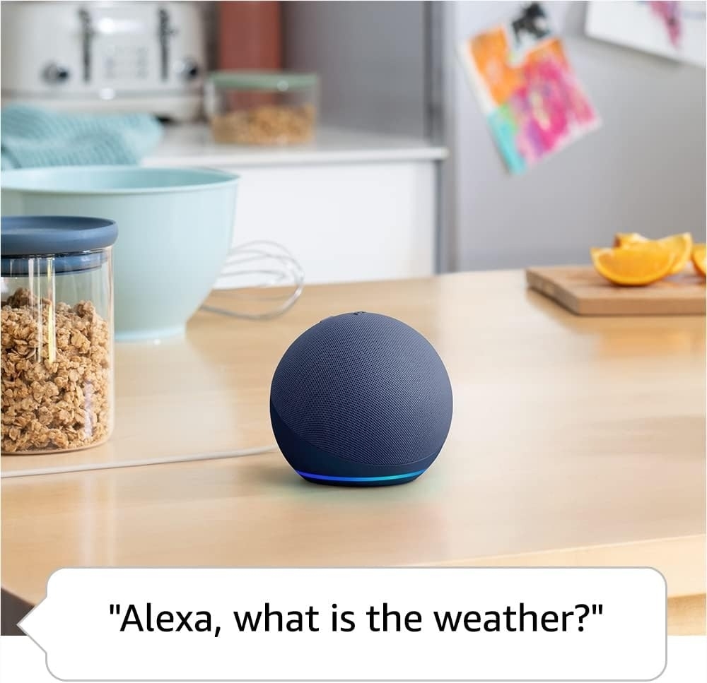An echo dot sitting on a table with the caption &quot;Alexa, what is the weather.&quot;