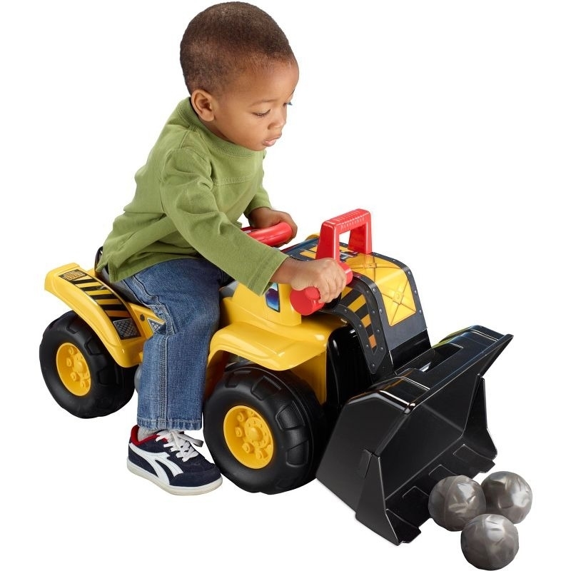 Child rides on an excavator toy